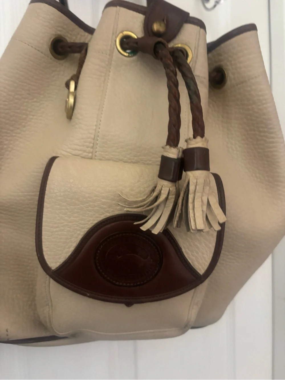 Dooney & Bourke Beige and Brown Leather Drawstring Bucket Backpack